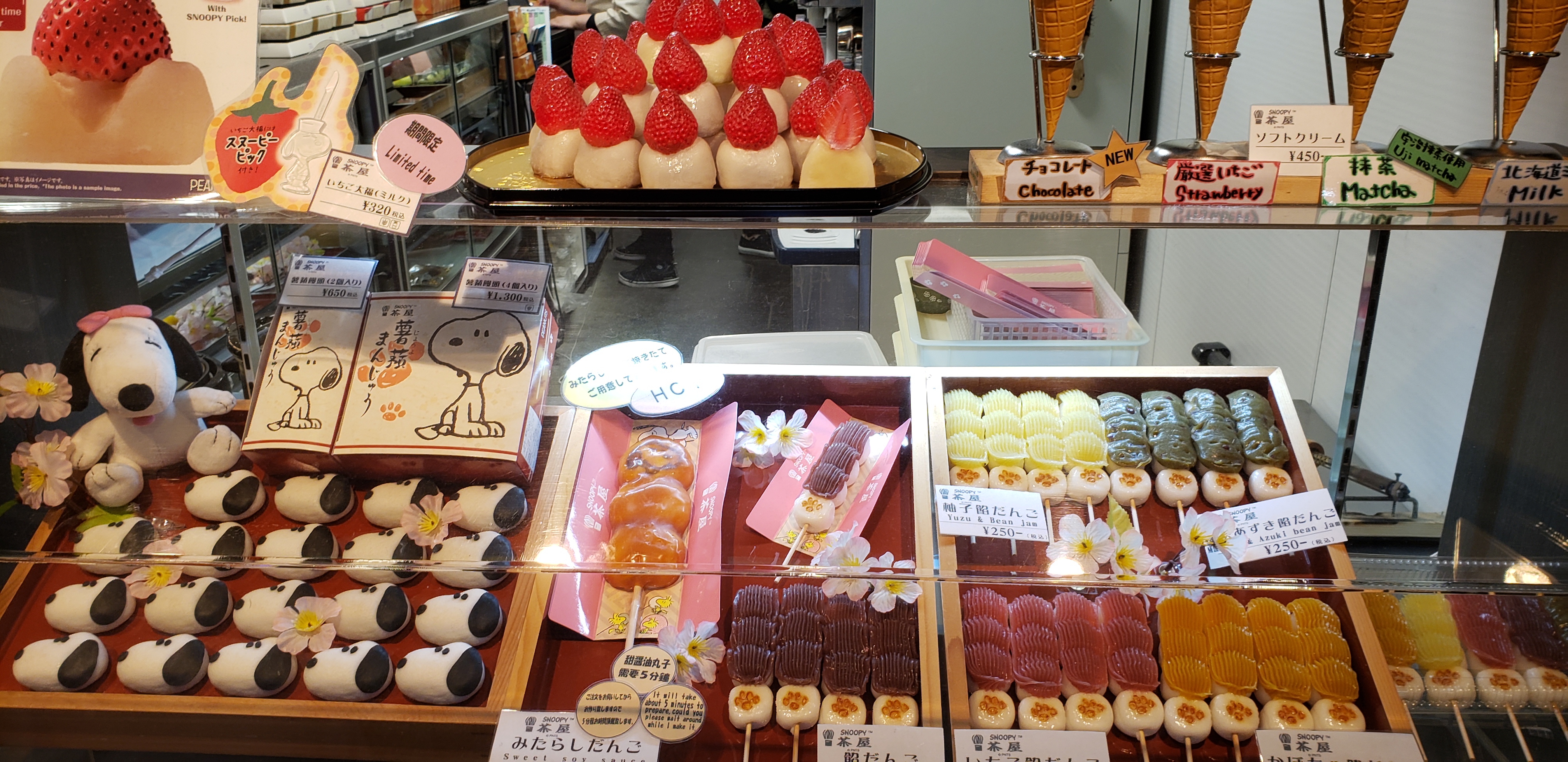 Snoopy snacks, rice balls on skewers behind display case